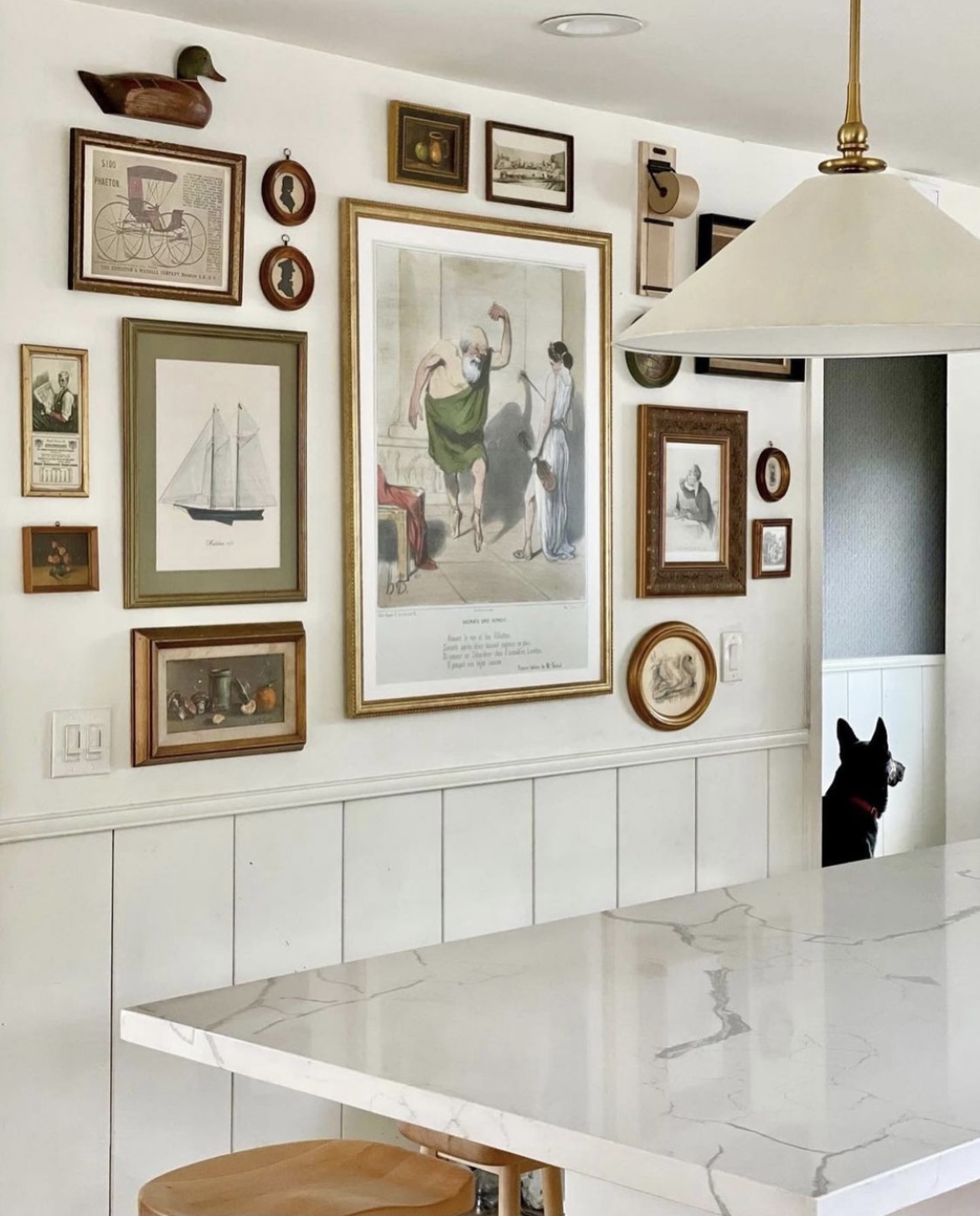 gallery wall in kitchen, gallery wall tips, kitchen renovation, quartz countertops, modern traditional, 1950s beach cottage, shiplap wainscotting, swiss coffee wall paint, white wall paint, modern traditional home, kitchen pendants, art in kitchen, gallery wall ideas