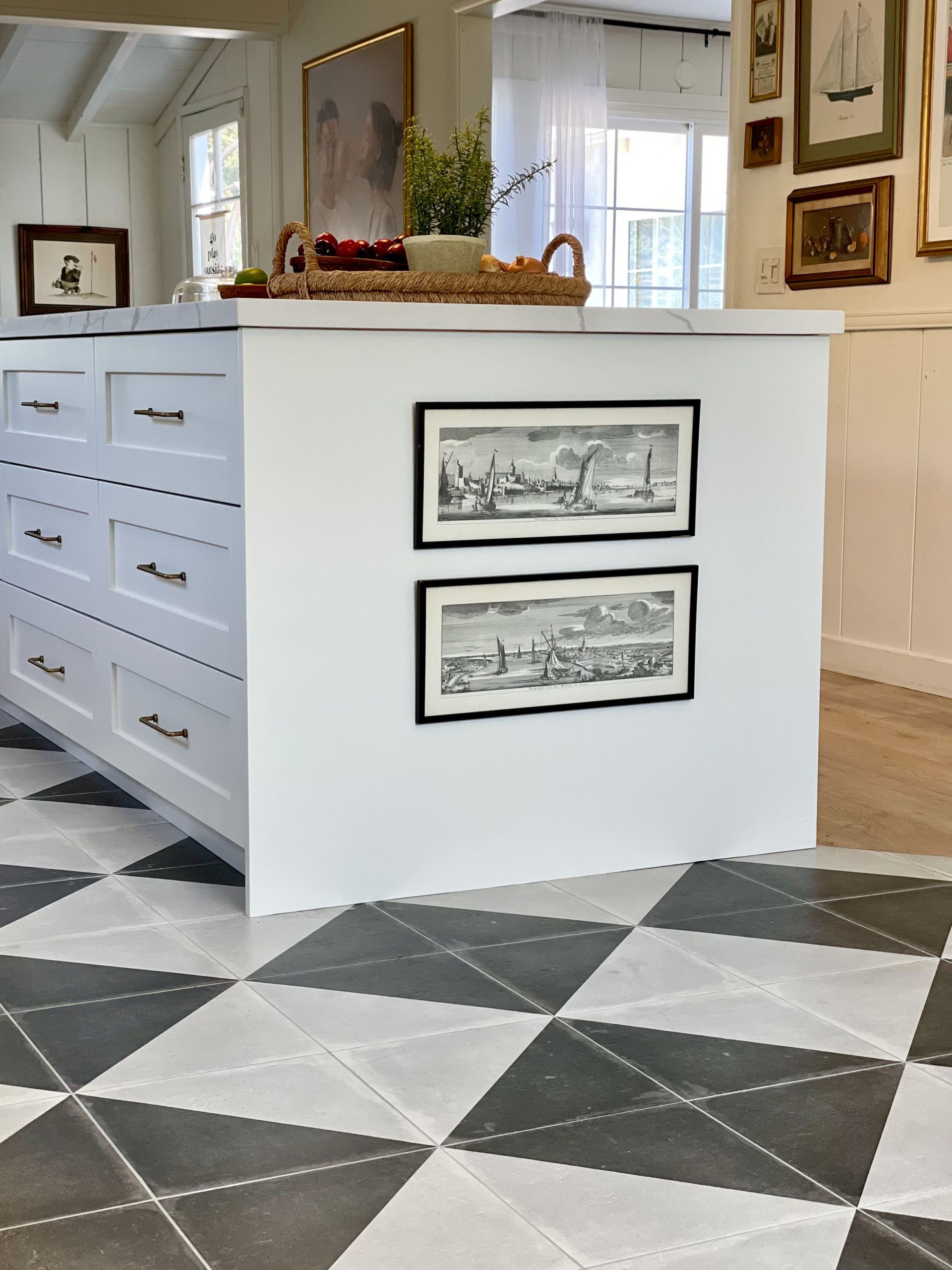 Art on kitchen island, checkered floors, wood and tile floor transition, ikea kitchen, white kitchen