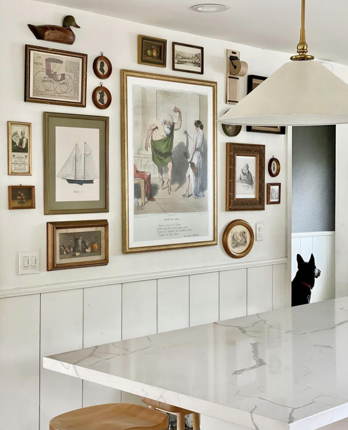 Kitchen gallery wall, kitchen pendant, swiss coffee wall paint, art in kitchen, thrifted art, modern traditional home, shiplap wainscoting, calacatta laza quartz countertops, 1950 beach house, pretty on fridays, modern vintage, thrifted home, displaying art in unexpected places