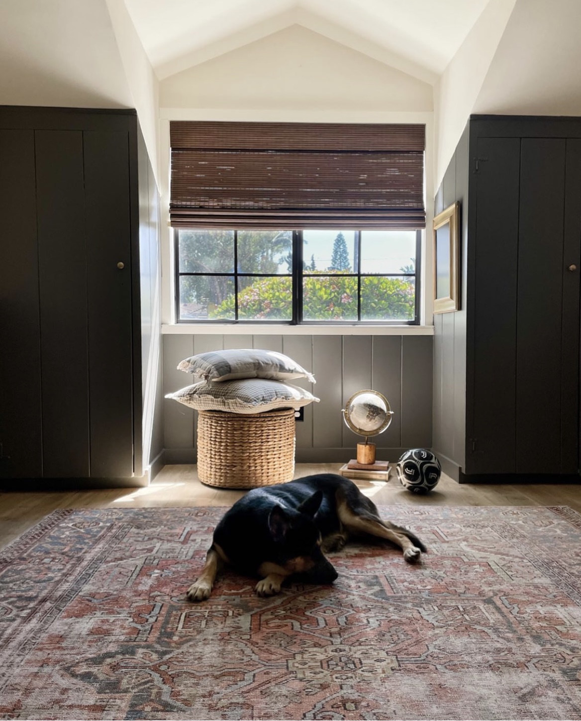 Boys soccer room, kids soccer themed room, kendall charcoal benjamin moore, dark gray paint, black paint, shiplap walls, dunn edwards swiss coffee paint, built in closets, window in middle of closet, wooden woven shades, interior dormer window, vintage rug, laminate floors