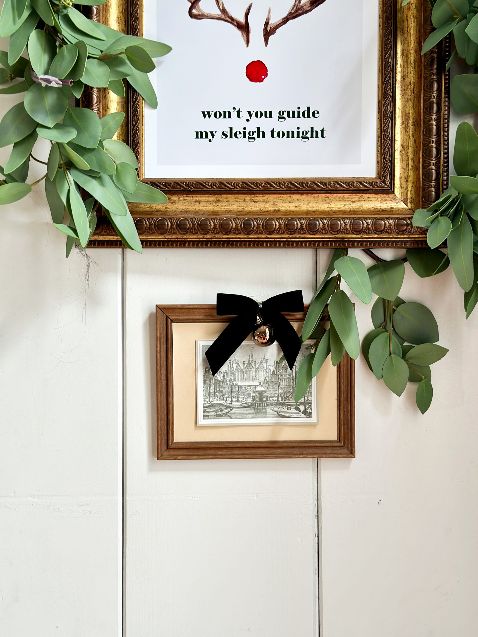 easy and budget friendly ways to decorate for christmas, decorating with bows, decorating art for christmas, christmas decor ideas, bows on art, christmas art, decorating art for christmas, mopboard black benjamin moore, swiss coffee paint color, white paint color, bow in window, shiplap walls, thrifted christmas, bells on door, laminate floors